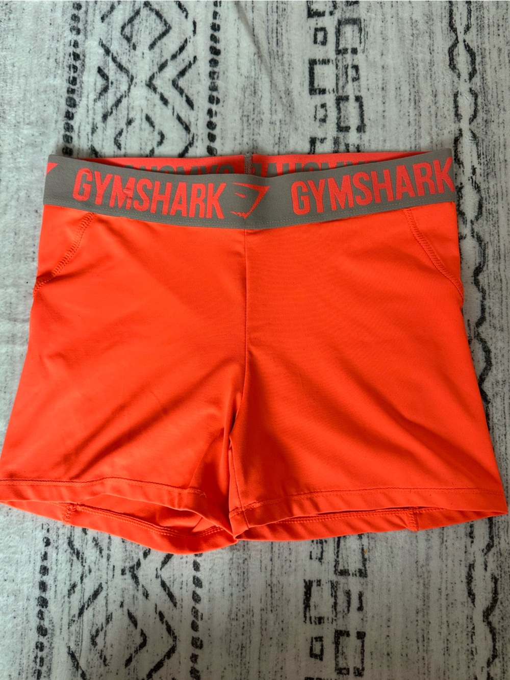 Gymshark Bright Orange Performance Shorts with Gray Logo Waistband